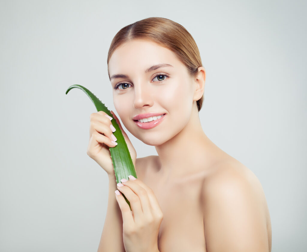 Beautiful woman with healthy skin and aloe vera leaf, skincare concept
